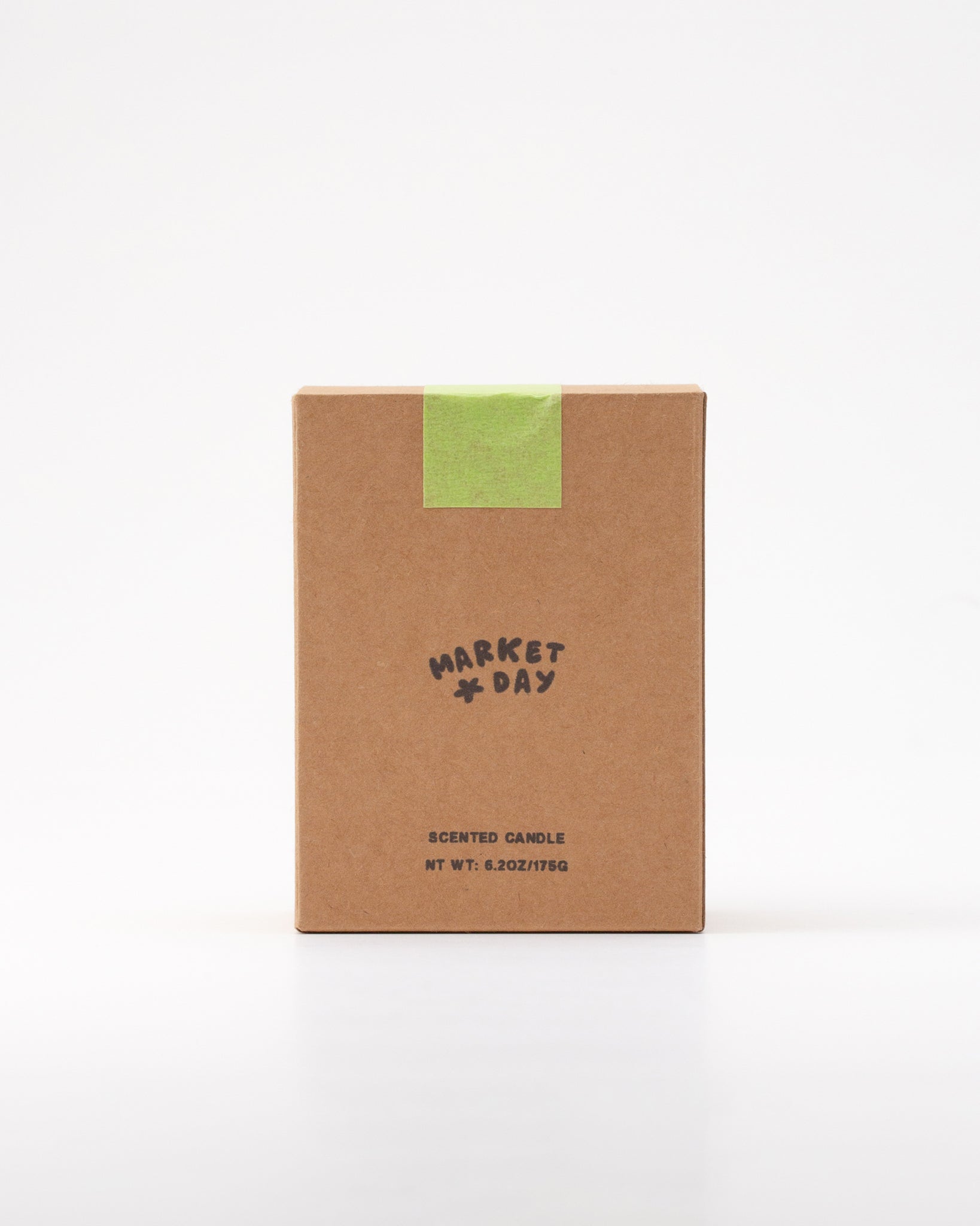 Kraft paper candle box with 'Market Day' branding on a white background