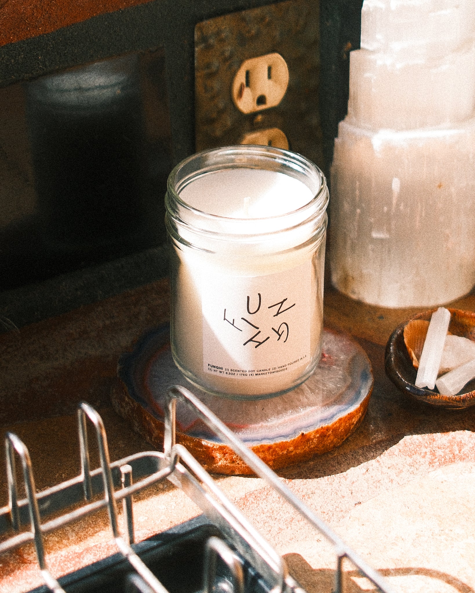 Candle labeled 'Funghi' on a kitchen countertop with a vintage background