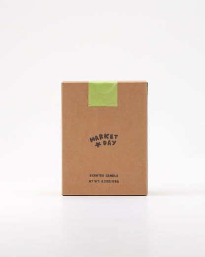 Kraft paper candle box with 'Market Day' branding on a white background