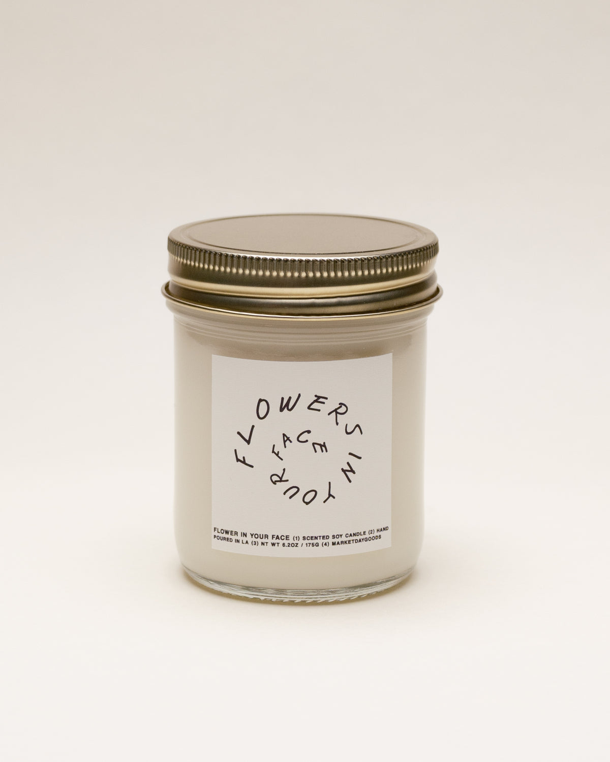 flowers in your face soy candle with notes of all the flowers and green stems