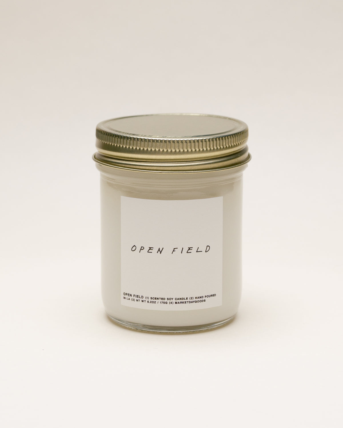 open field soy candle with notes of hay, violet leaf and reclaimed wood